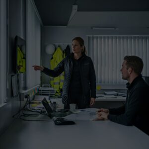 Kvinna och man på byggkontor diskuterar arbetsmiljö vid en BAM utbildning, Bättre arbetsmiljö.